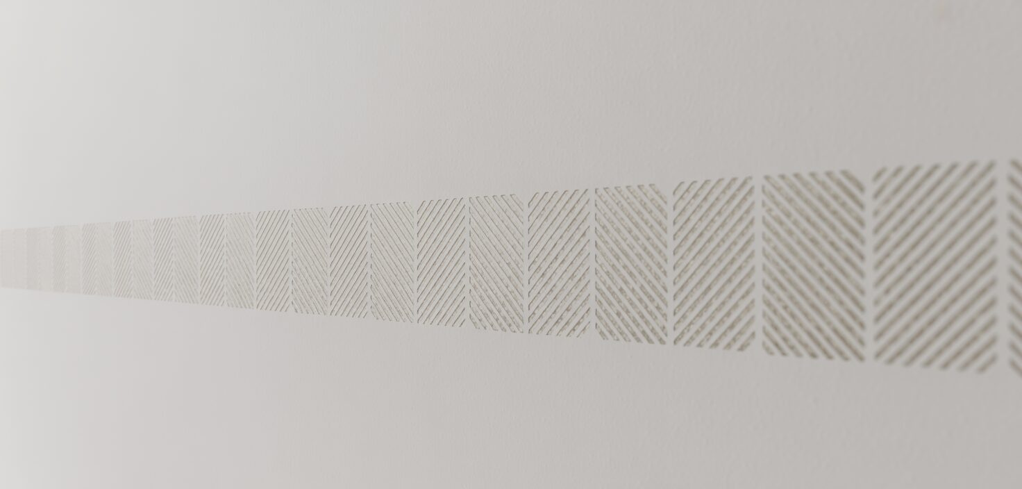 Schablonmålad vägg med geometriskt mönster i minimalistisk stil.